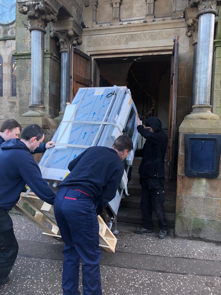 Delvado installation team carrying equipment into a venue